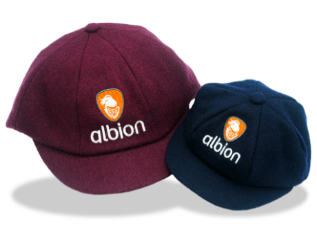 One Albion mini baggy cap in dark navy, beside an Albion baggy cap in burgundy, each featuring the orange Albion logo embroidered on the front.