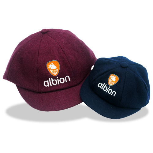 One Albion mini baggy cap in dark navy, beside an Albion baggy cap in burgundy, each featuring the orange Albion logo embroidered on the front.