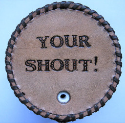 Your Shout! message in fancy stamped font on leather stubby cooler bottom.
